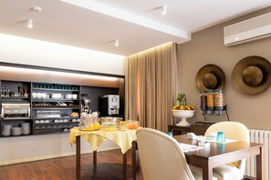Enjoy a delicious breakfast at the breakfast bar, featuring a coffee machine and a variety of breakfast items.
