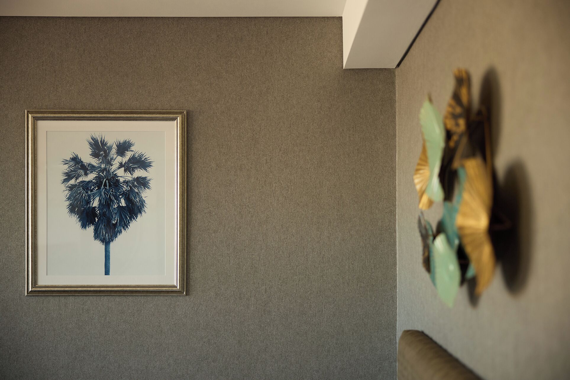 Une œuvre d’art encadrée représentant un arbre sur un mur à texture.
