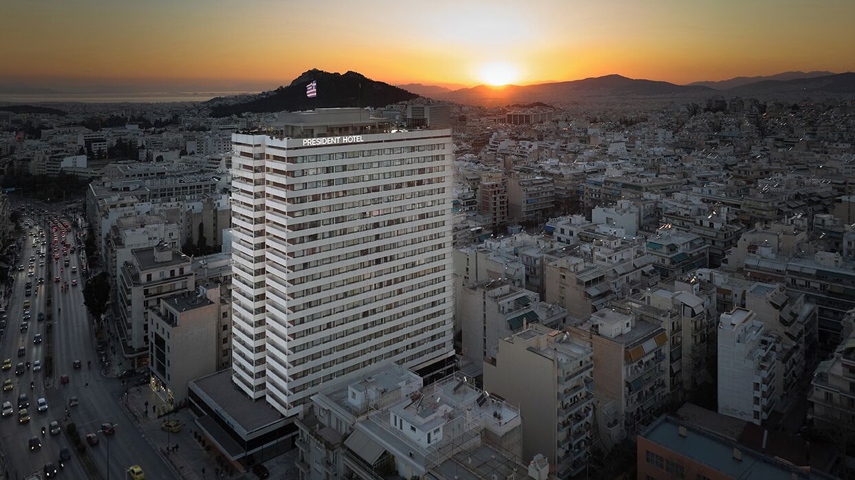 A high-rise hotel with multiple floors, surrounded by a densely packed urban area.