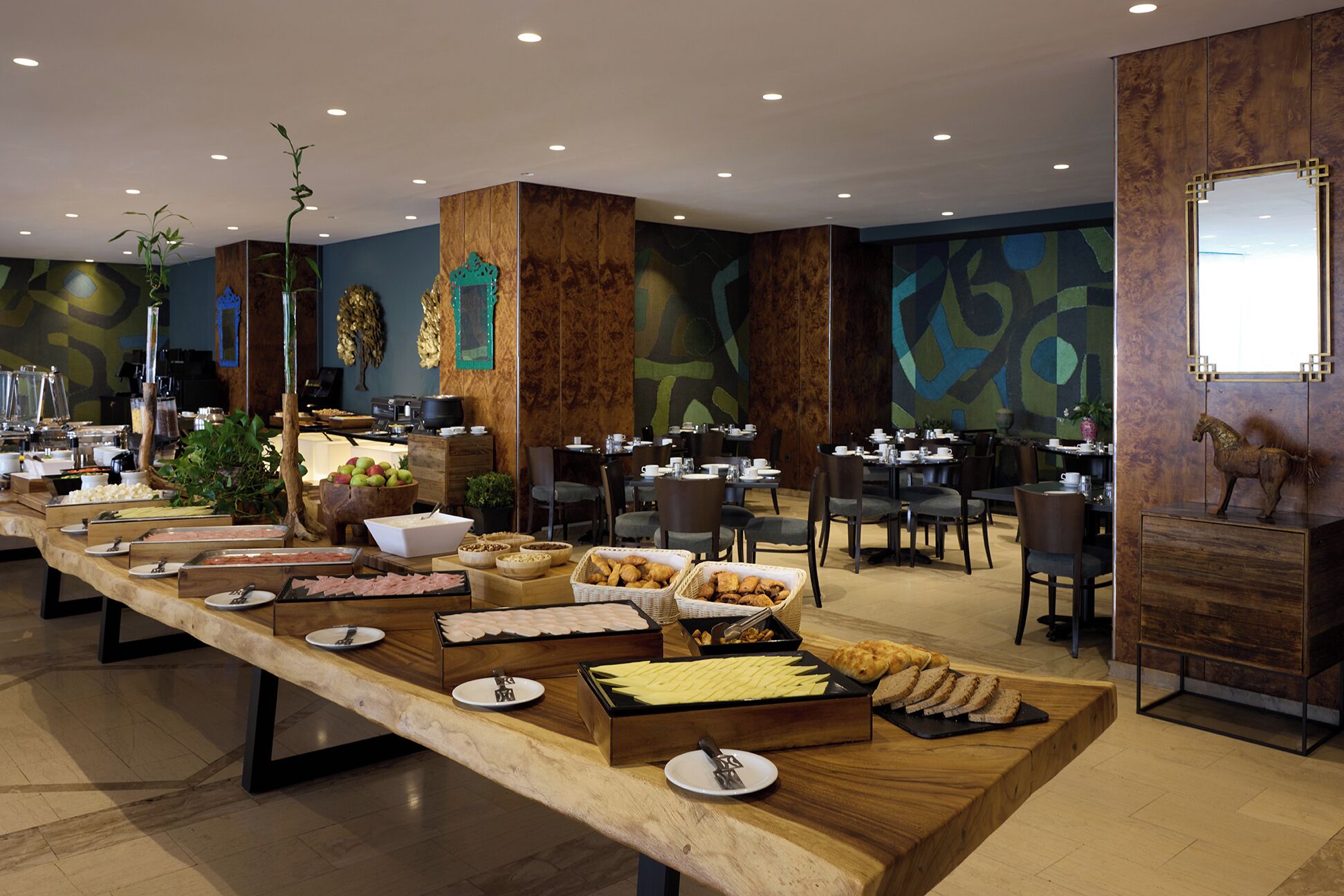 A buffet setup with various food items and a long wooden counter.