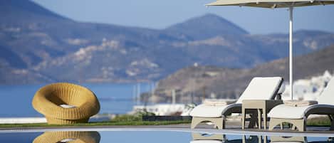 Seasonal outdoor pool, open 9:30 AM to 9 PM, pool umbrellas