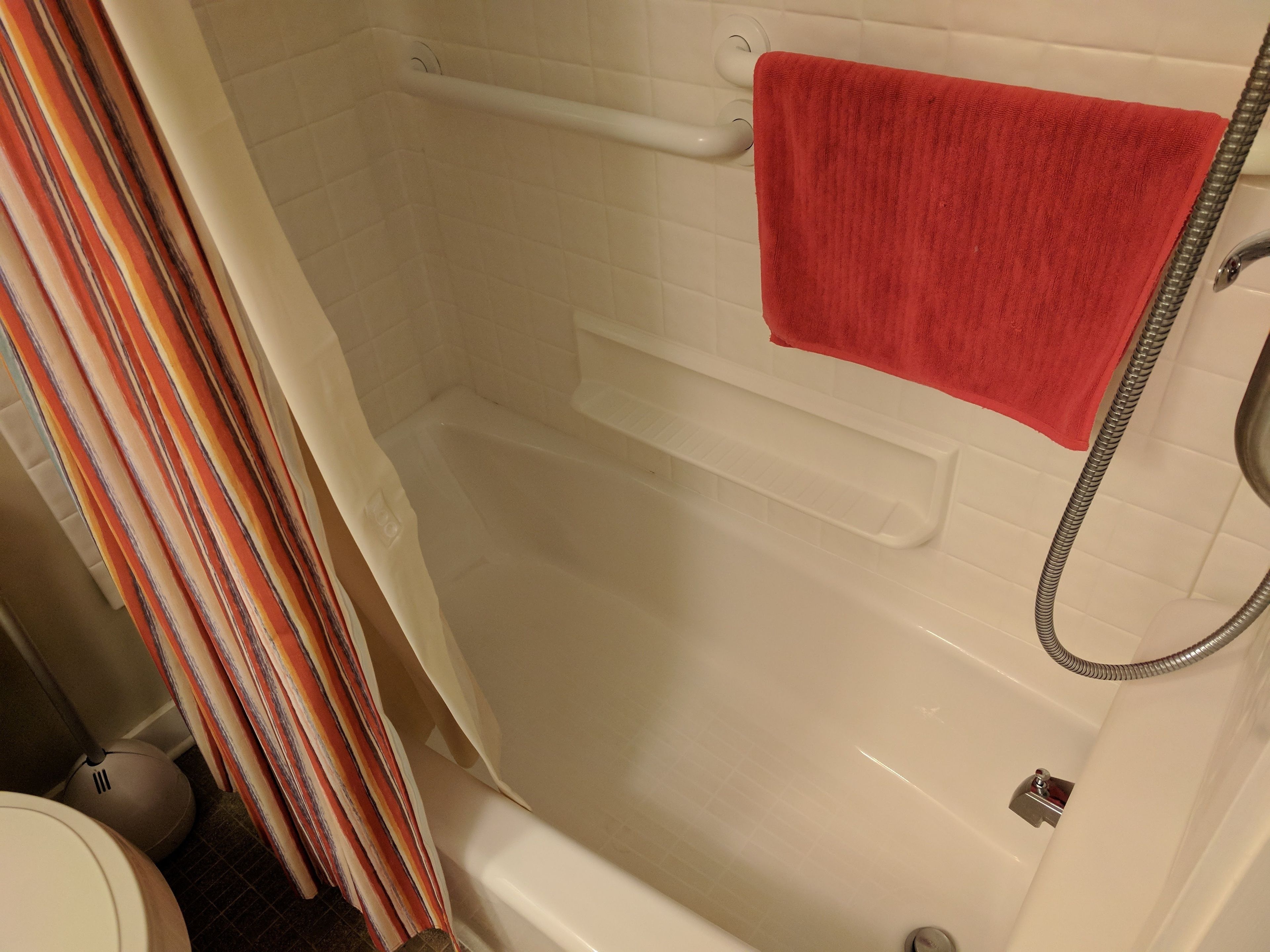 A bathroom with a bathtub, a shower, and a toilet.