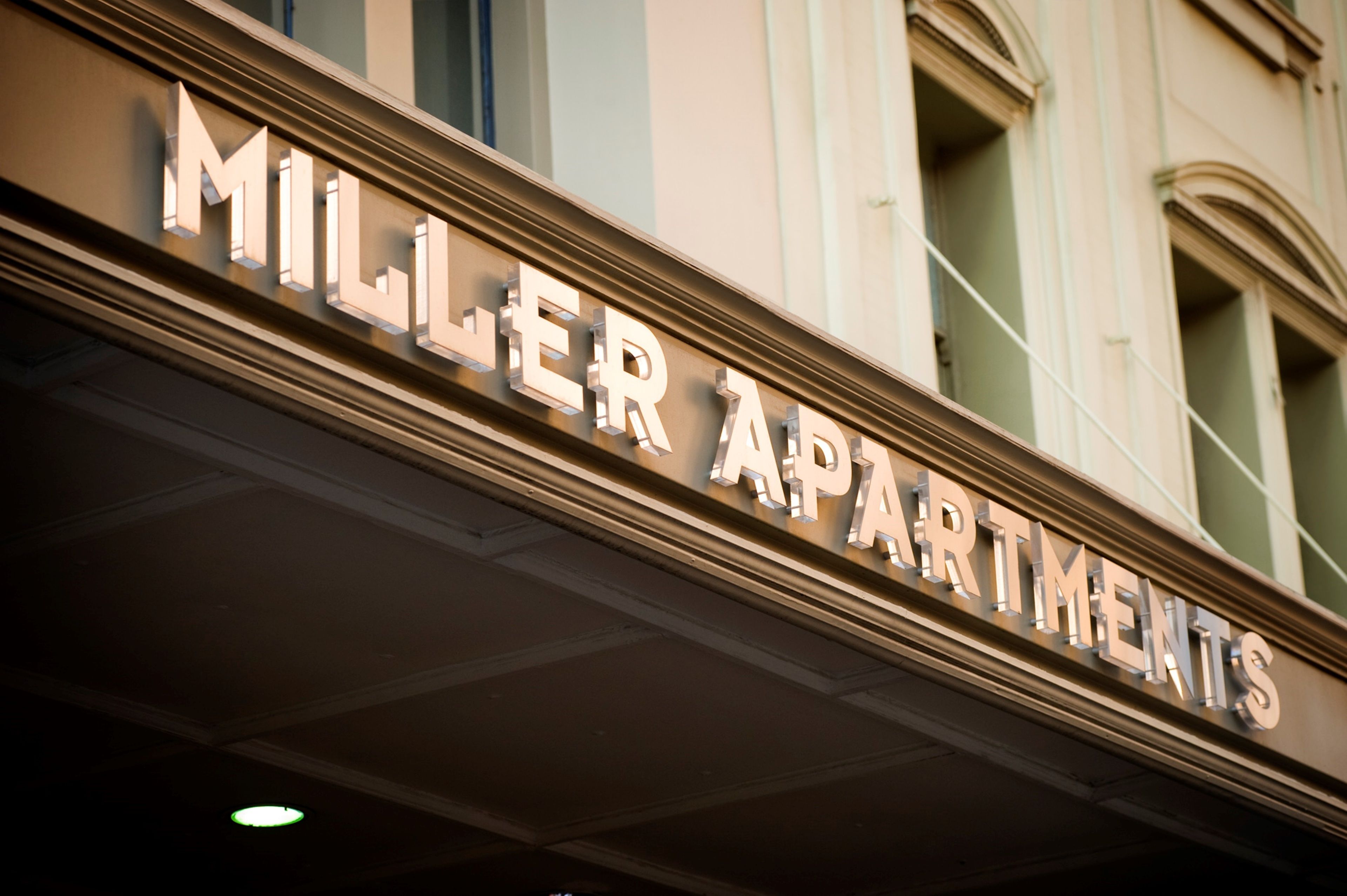 A building with the sign "MILLER APARTMENTS" indicating it is an apartment complex.