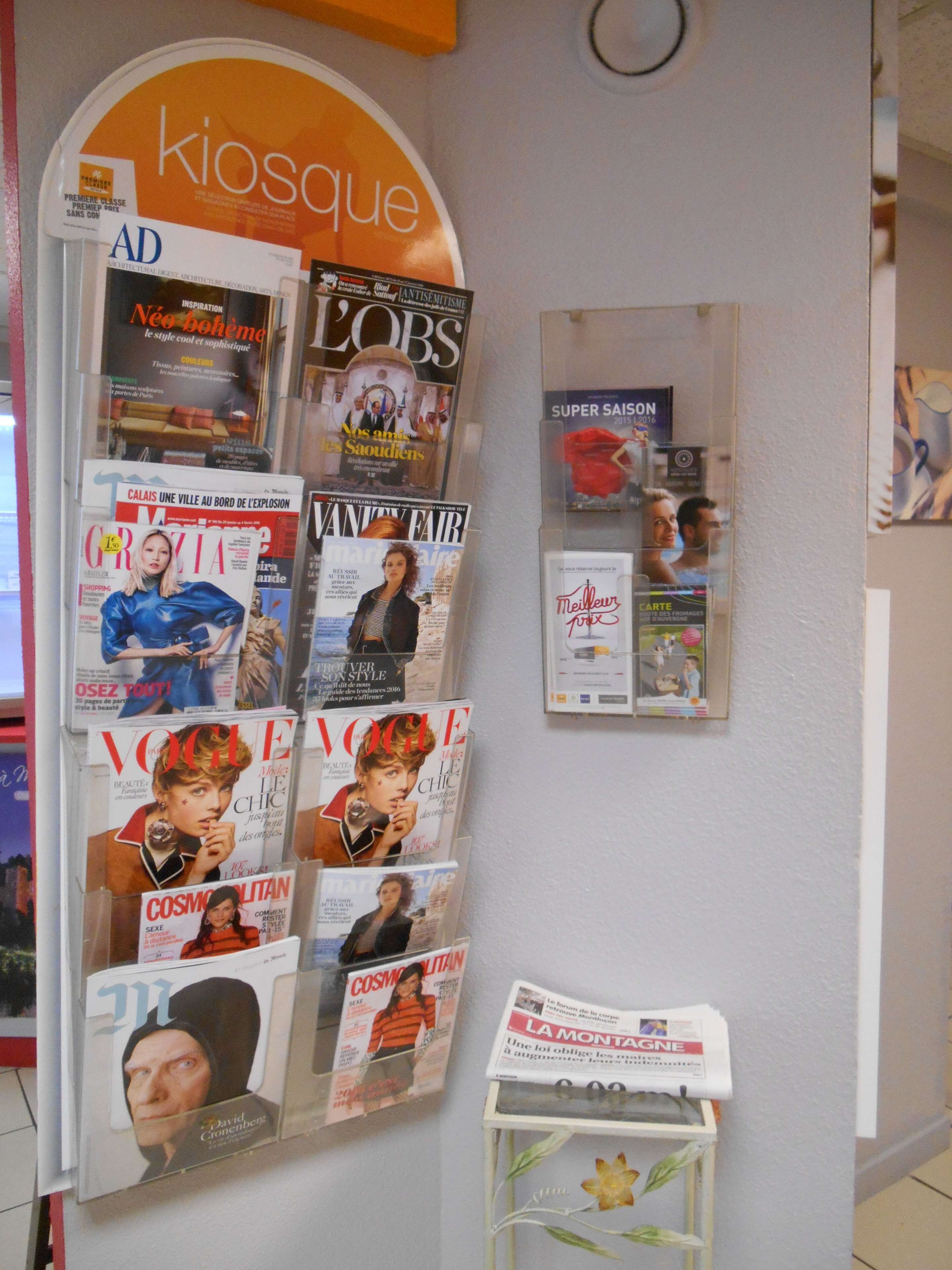 A magazine rack with various issues of Vogue, Cosmopolitan, and other publications.