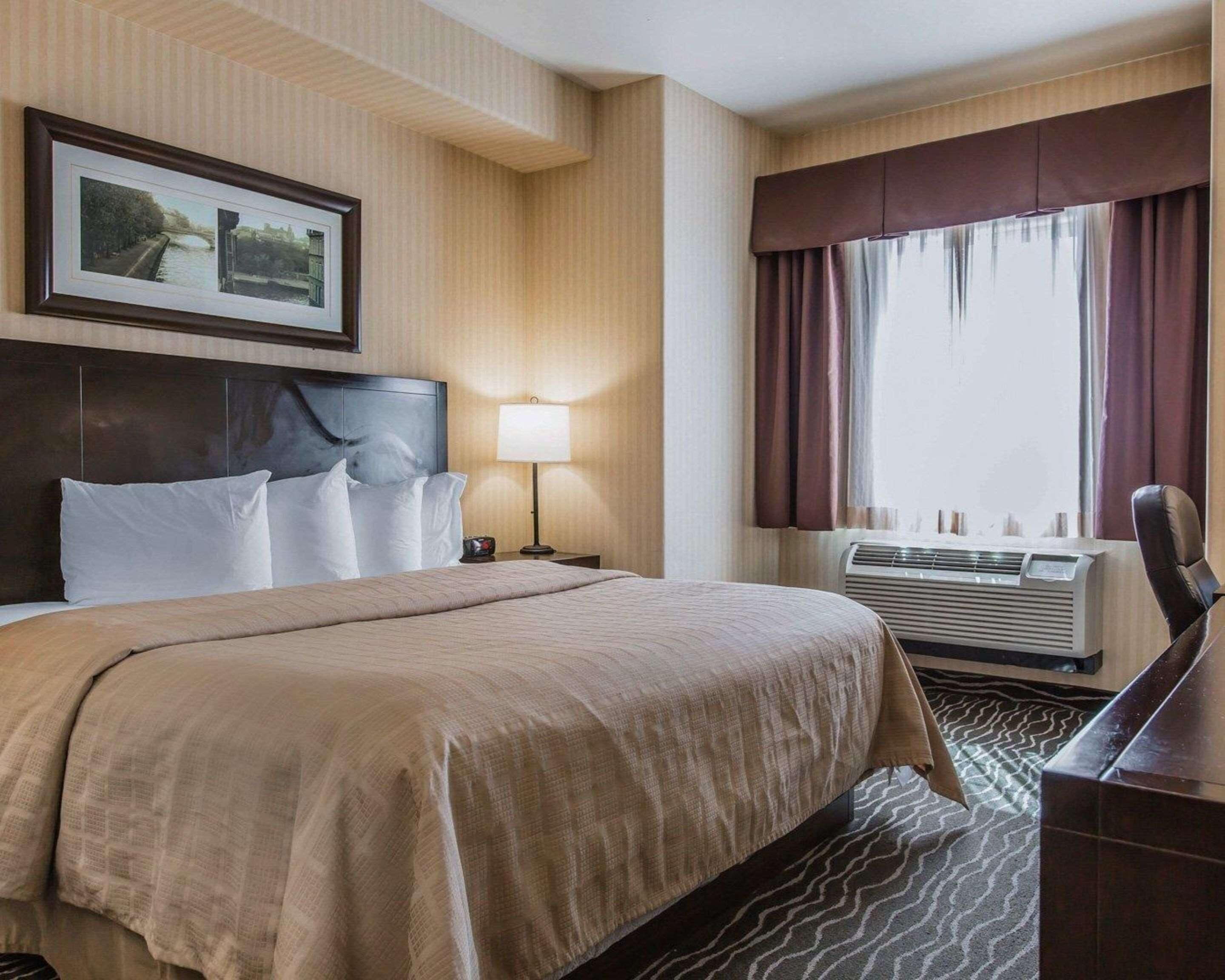 Hypo-allergenic bedding, desk, laptop workspace, blackout curtains