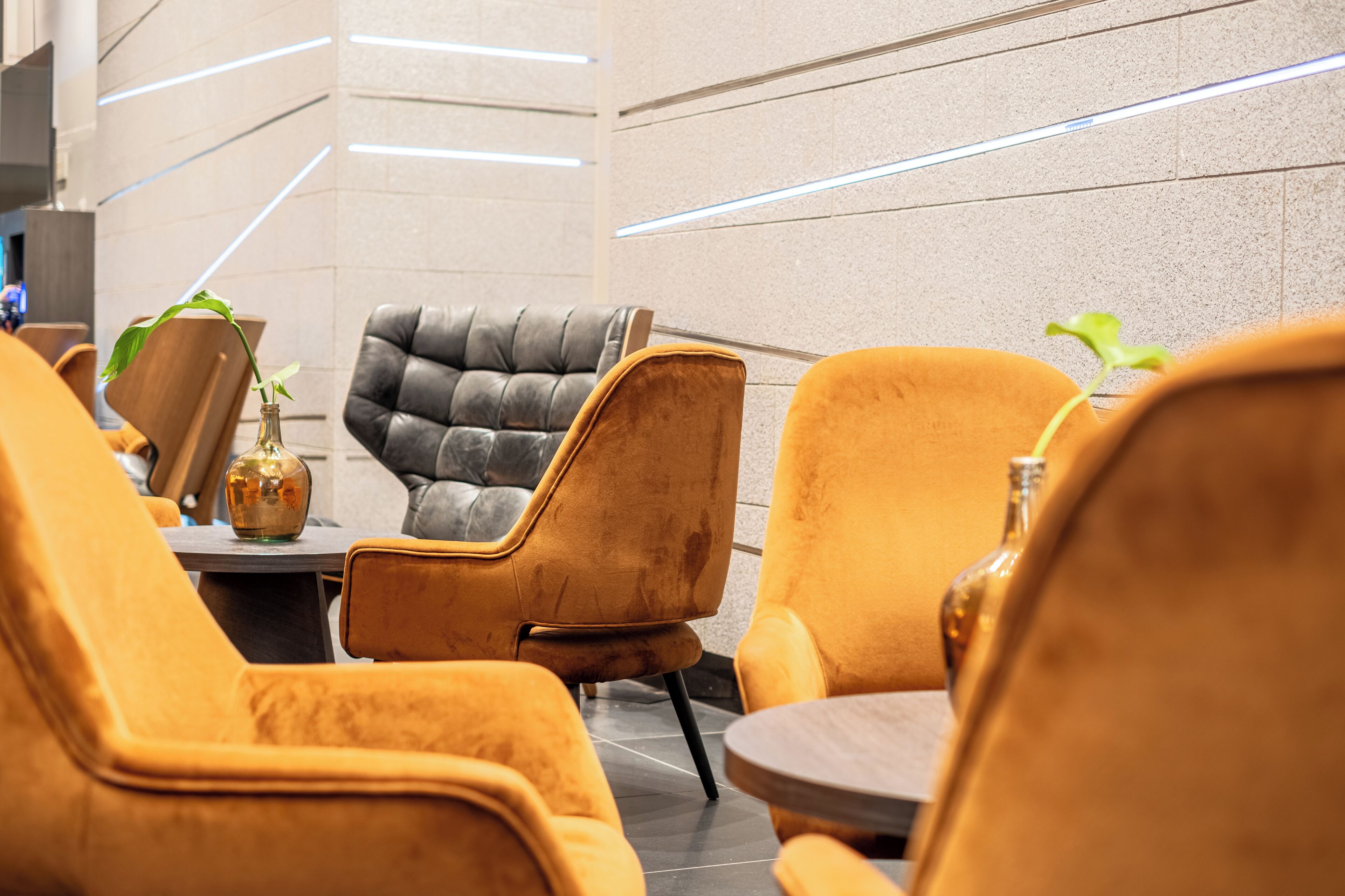 Un intérieur moderne avec des sièges confortables, une table surmontée d’un plateau en marbre et un design minimaliste.