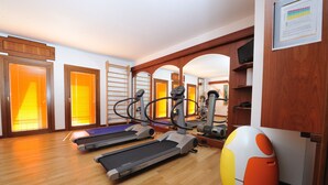A gym with treadmills, elliptical machines, and a stationary bike. - Hotel Roxy Plaza (Soave)