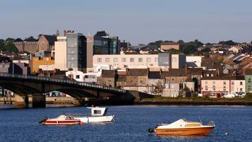 A bridge over a river with boats docked nearby.