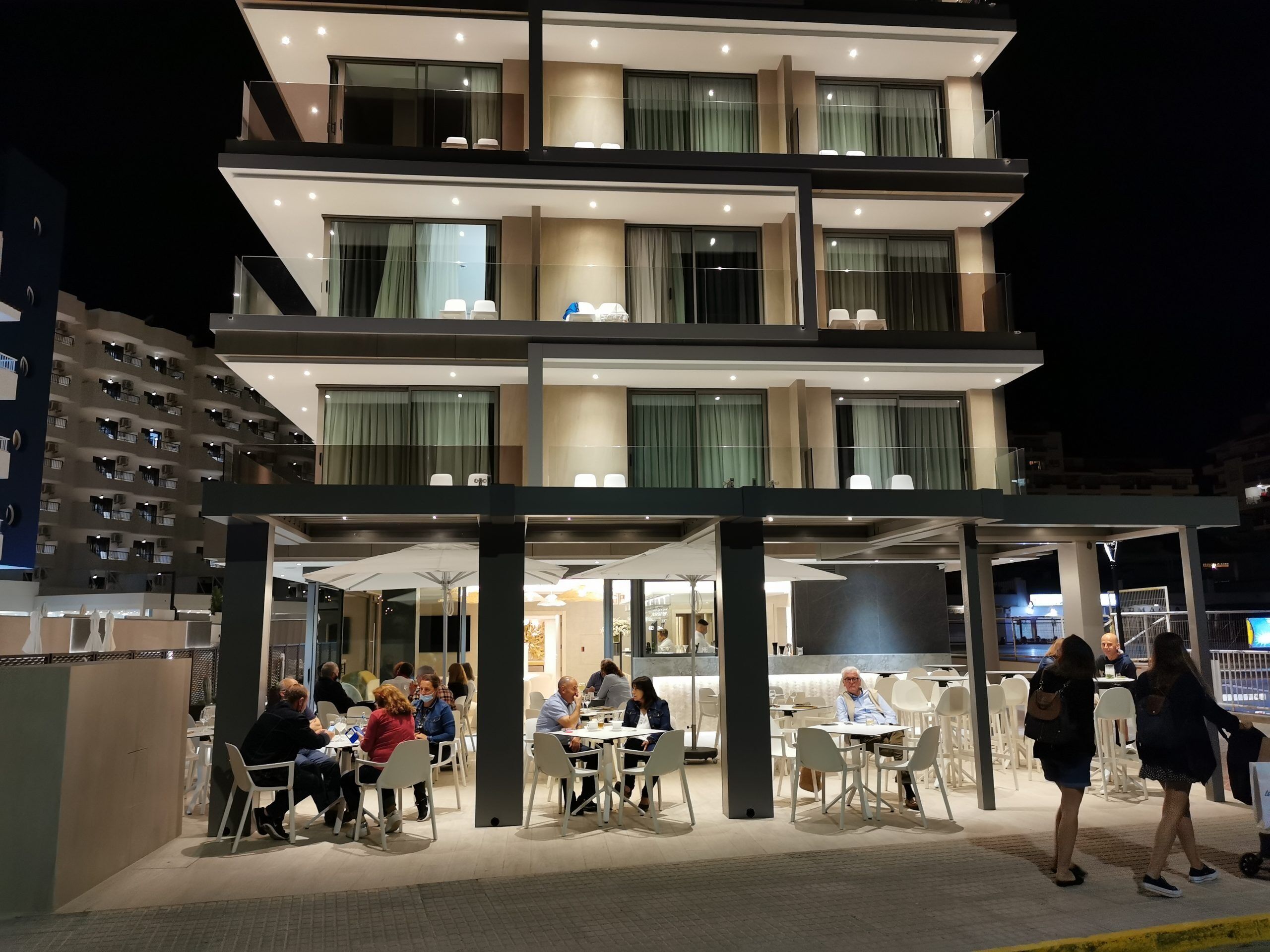 Un hotel de varios pisos con zonas de estar al aire libre y un diseño arquitectónico moderno.
