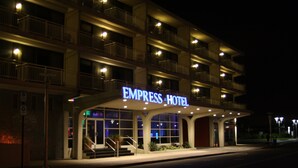 A multi-story hotel with a prominent sign reading "EMPRESS HOTEL".