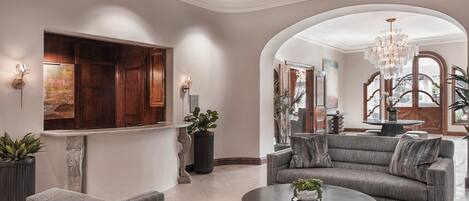 A spacious living area with a sofa, coffee table, and a fireplace.