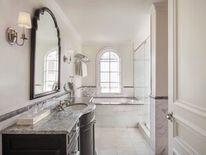 A spacious bathroom with a large vanity, a bathtub, and a walk-in shower. - Liora Estate (Healdsburg)