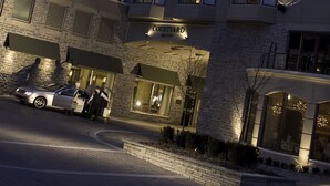 A multi-story hotel with a modern architectural design, featuring a prominent entrance with a sign, a parking area, and a well-lit facade. - Courtyard by Marriott Halifax Downtown (Halifax)