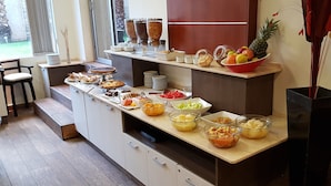 A breakfast buffet with various food items and a fruit bowl. - Villaggio Hotel Boutique (Mendoza)