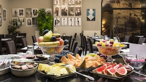 A buffet table with various fruits and cheeses. - Carat Boutique Hotel (Budapest)