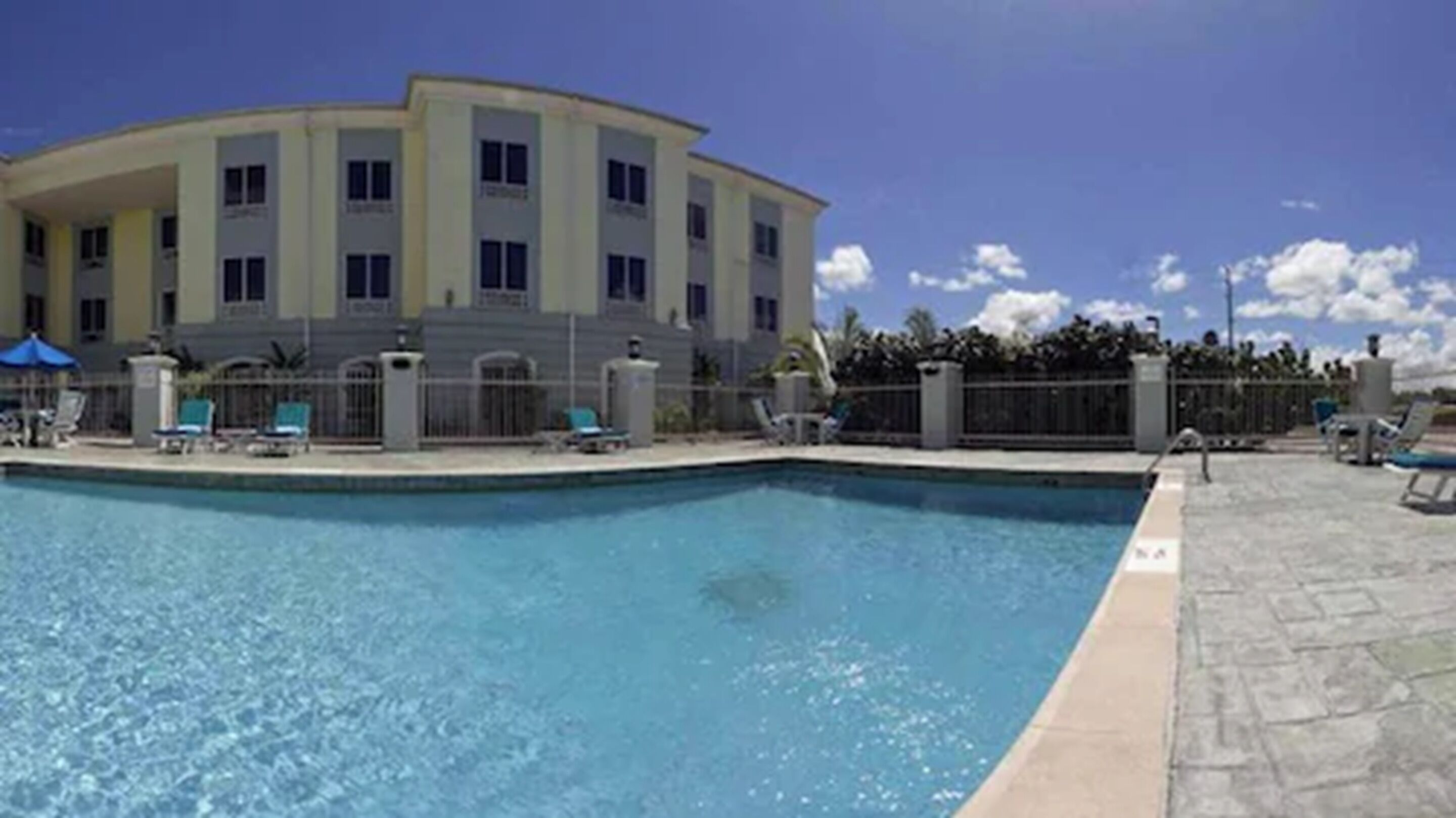 outdoor pool, open 6:00 am to 10:00 pm, pool umbrellas, pool loungers