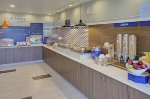 A modern breakfast bar with a variety of food options, including cereal and fruits. - Holiday Inn Express Hotel & Suites Le Mars by IHG (Le Mars)
