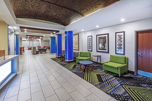 A hotel lobby with a reception desk, seating area, and a patterned carpet. - Holiday Inn Express Hotel & Suites Laredo-Event Center Area by IHG (Laredo)