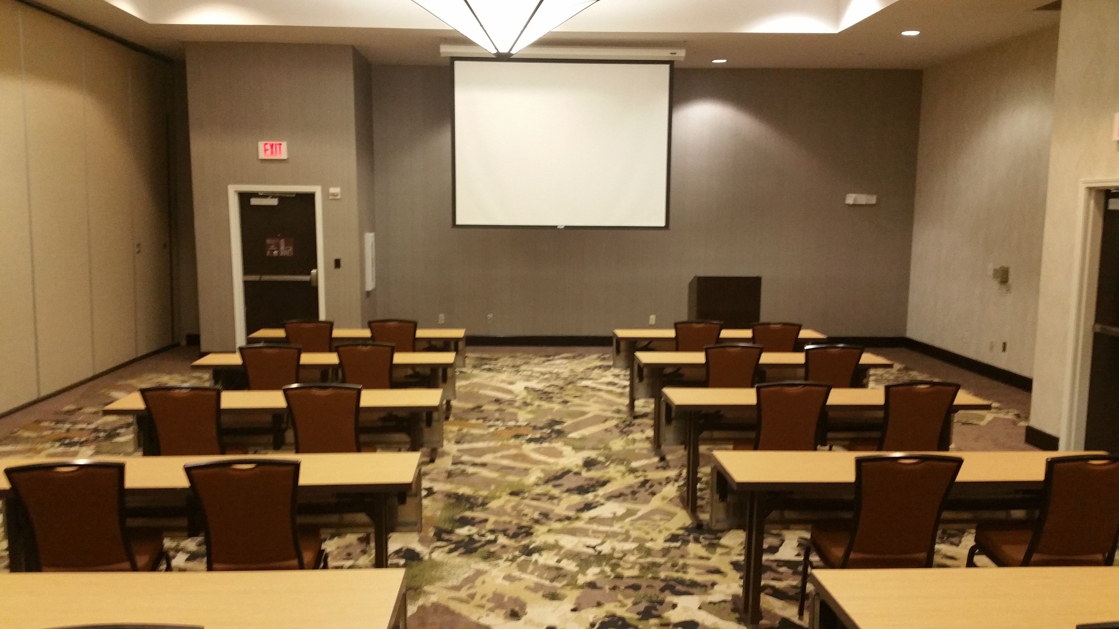 A conference room with tables and chairs arranged for meetings.