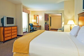 A hotel room with a bed, a desk, a chair, a television, and a bathroom. - Holiday Inn Express Hotel & Suites Birmingham - Inverness by IHG (Birmingham)
