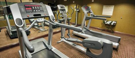 A fitness center with treadmills, ellipticals, and a stationary bike.