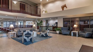 A spacious lobby with a high ceiling, a staircase, and a reception desk. - Comfort Inn & Suites Lake George (Lake George)
