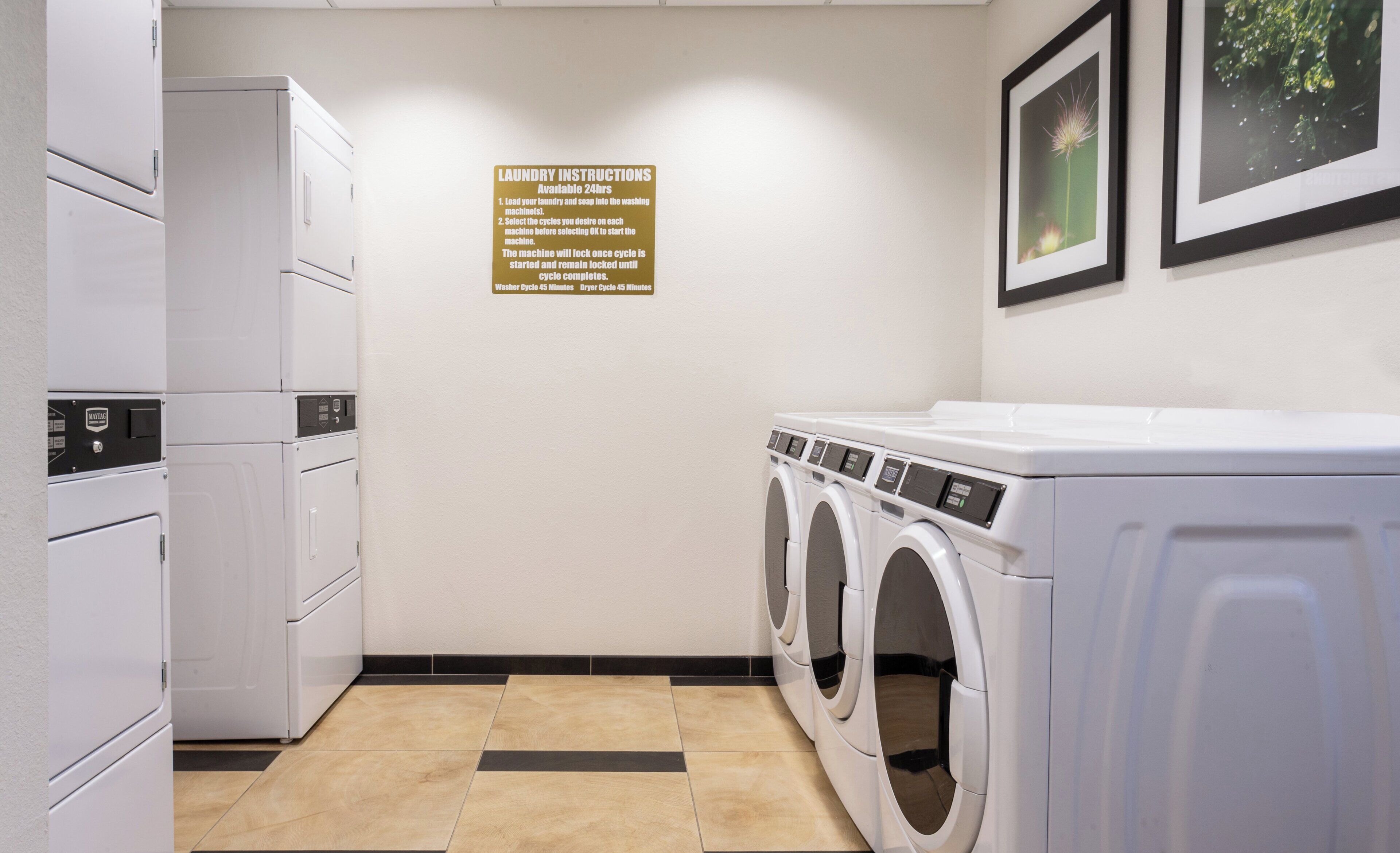 A laundry room with a sign detailing instructions, a washer, and a dryer.