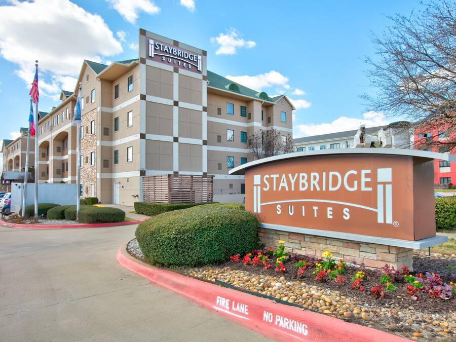 Staybridge Suites hotel with a sign, a parking lot, and a fire lane.