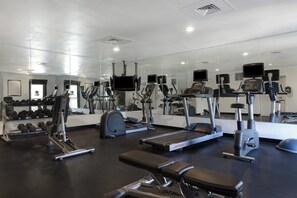A gym with various exercise equipment, including treadmills, stationary bikes, and weight machines. - Staybridge Suites Tallahassee by IHG (Tallahassee)