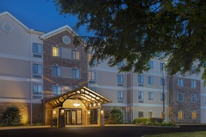 A multi-story hotel with a stone facade, a covered entrance, and a well-lit exterior. - Staybridge Suites Tallahassee by IHG (Tallahassee)