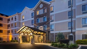 A multi-story hotel with a covered entrance, stone facade, and multiple windows. - Staybridge Suites Tallahassee by IHG (Tallahassee)