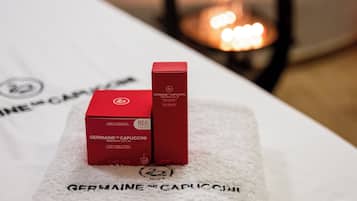 Two red boxes labeled 'GERMAINE DE CAPUCCINI' on a white towel with the same text.