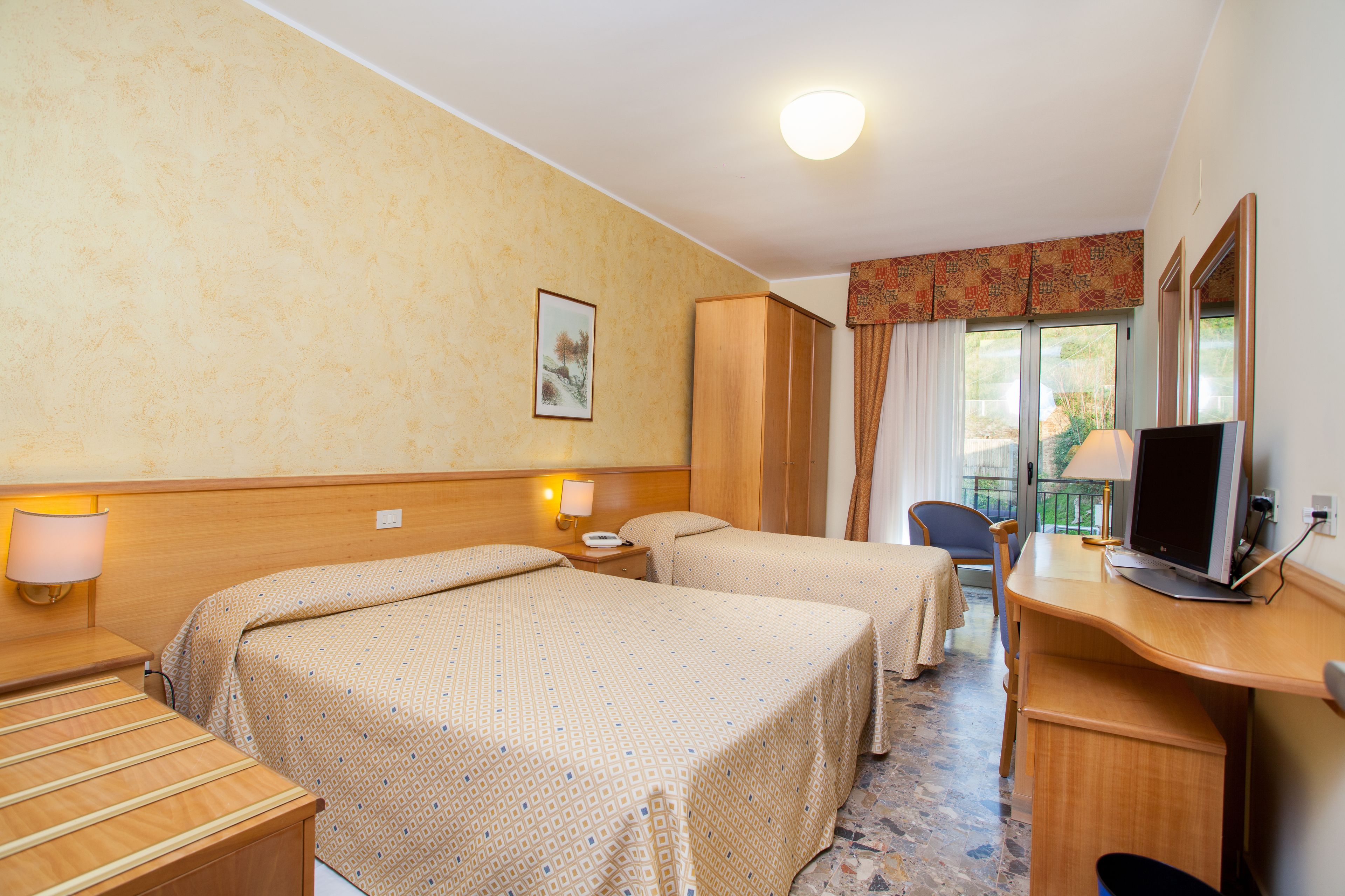 economy room, 1 queen bed, private bathroom, mountain view | minibar, in-room safe, desk, soundproofing