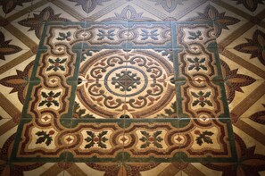 A detailed geometric tile pattern on a ceiling.