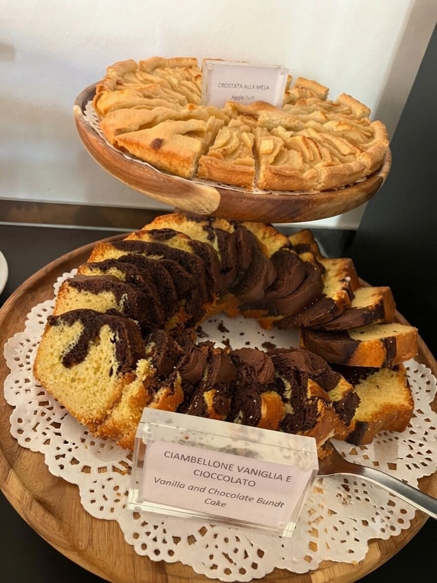 A display of baked goods including a layered cake and a bundt cake.