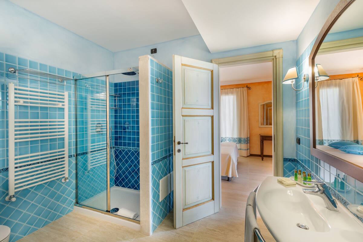 wellness presidential suite | bathroom | designer toiletries, hair dryer, bidet, towels