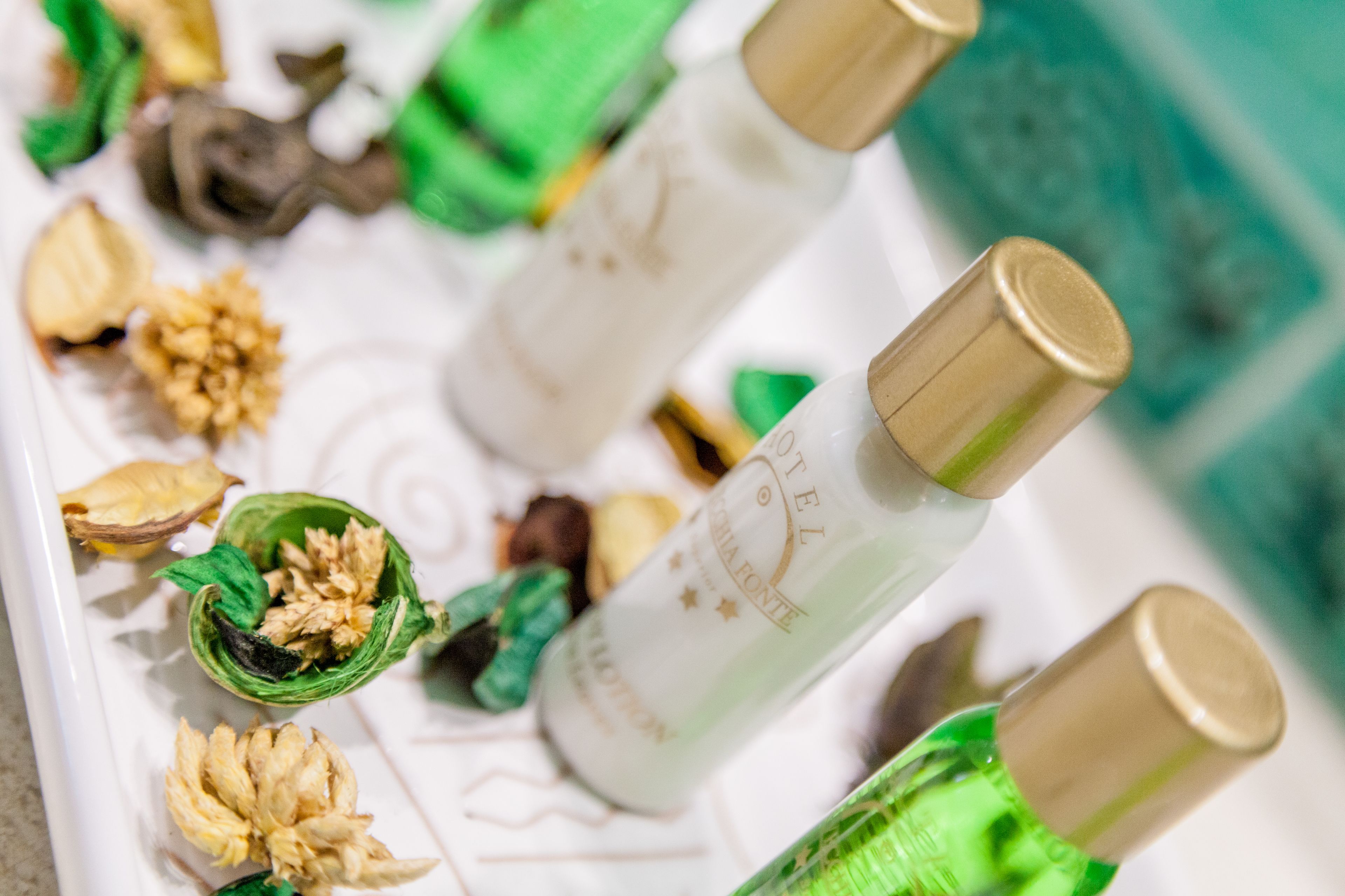 A tray with bottles and dried flowers.