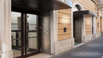 Hotel YES features a classic exterior with arched doorways and a traditional sign above the entrance.