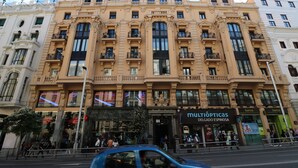 A multi-story building with ornate architectural details, including balconies and large windows.