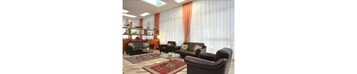 A living room with a sofa set, a coffee table, and a bookshelf.