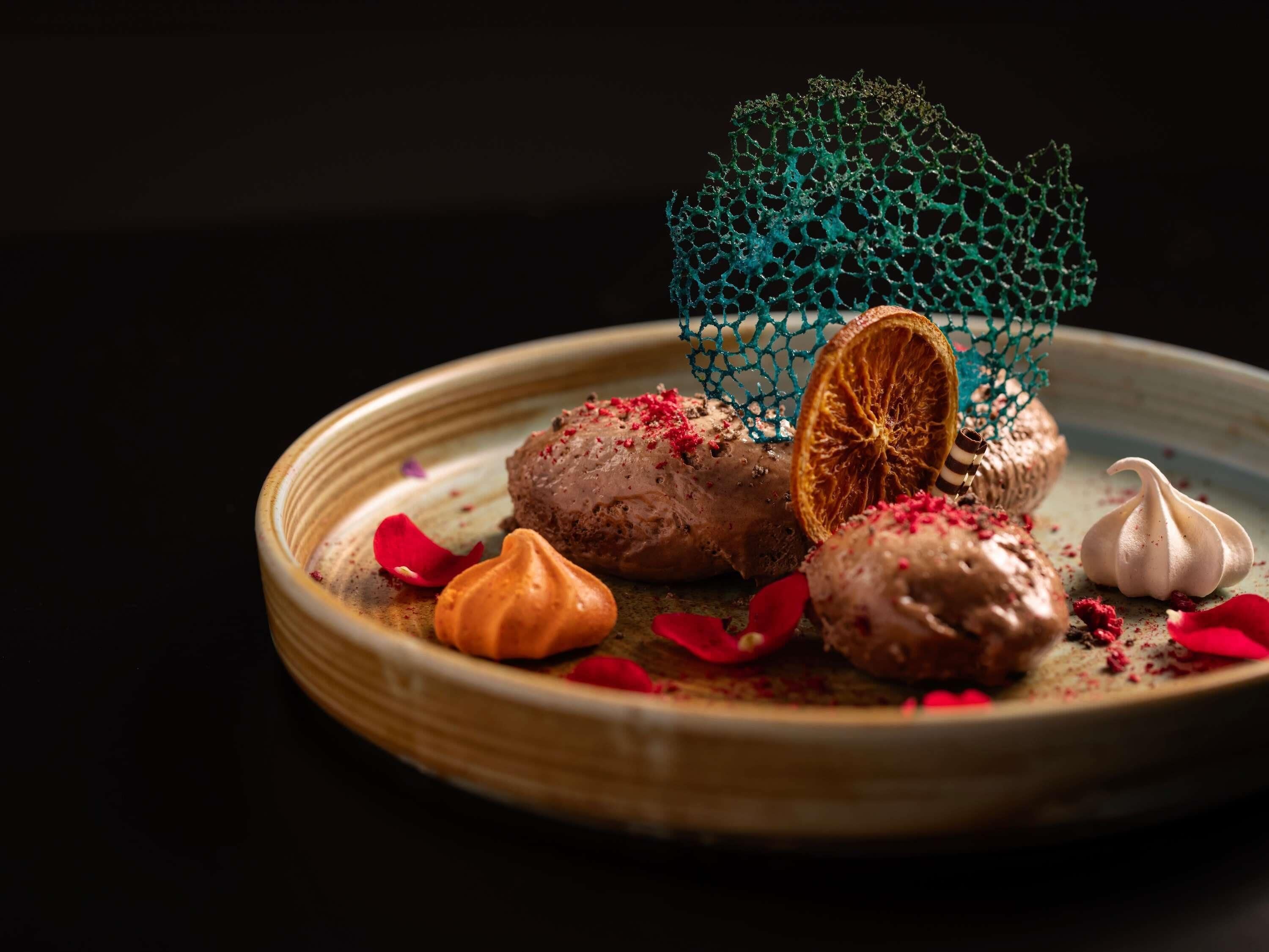 A dessert plate with various sweets and a decorative net.