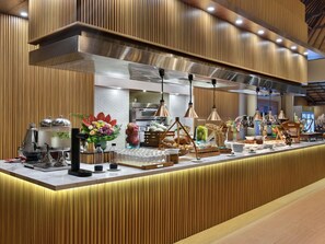A buffet setup with a variety of food items, a coffee station, and a beverage dispenser. - Novotel Bali Nusa Dua (Nusa Dua)