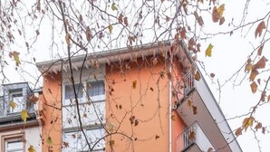A multi-story hotel with a prominent orange facade, balconies, and a visible entrance with a sign. - Hotel Himalaya Frankfurt City Messe (Frankfurt)
