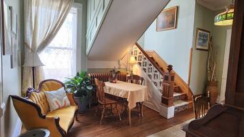 A cozy dining area with a wooden table, chairs, and a potted plant.