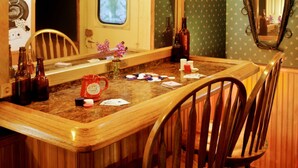 A wooden dining area with a large mirror, a window, and a ceiling with a spider decoration. - Featherbed Railroad B&B Resort (Nice)