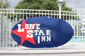 A sign for Lone Star Inn with a red star and white lettering.