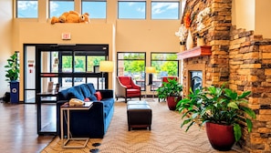 A lobby with a reception desk, seating area, and a fireplace. - Manitou Pikes Peak Hotel (Manitou Springs)