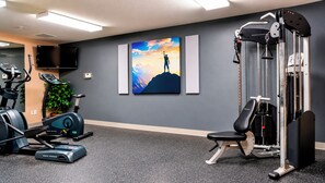 A gym with exercise equipment, a television, and a motivational painting. - Manitou Pikes Peak Hotel (Manitou Springs)