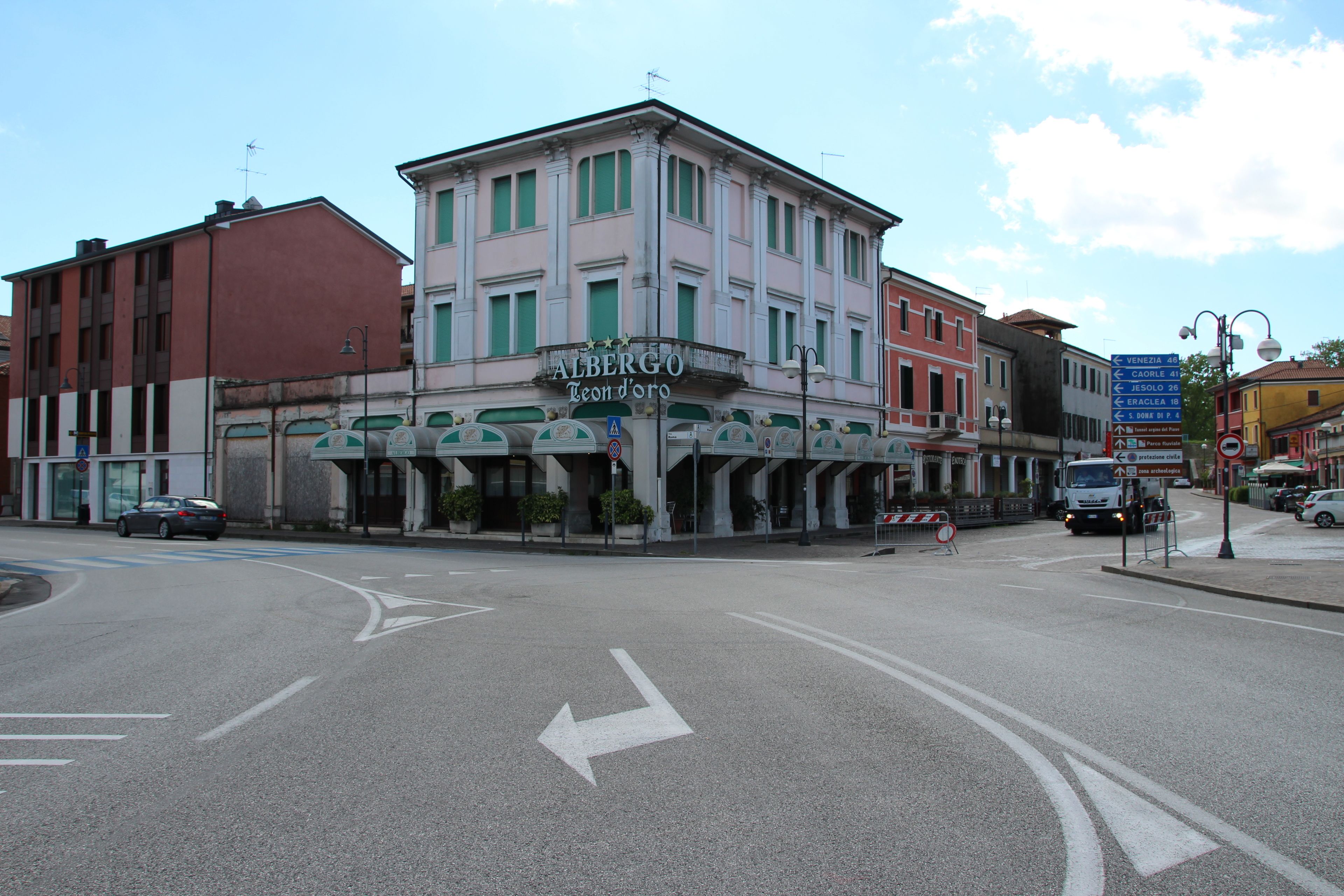 A building with a sign reading "ALBERGO Teondoro" at the entrance.