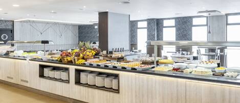 A buffet with various food items and a self-service beverage station.